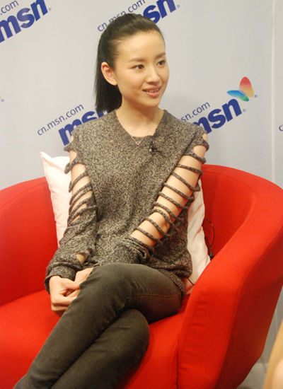 Sitting in an office building with a hollow knitted blouse  Essential